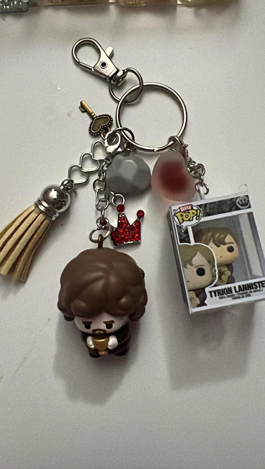 Keychain with charms and packaging on a white surface